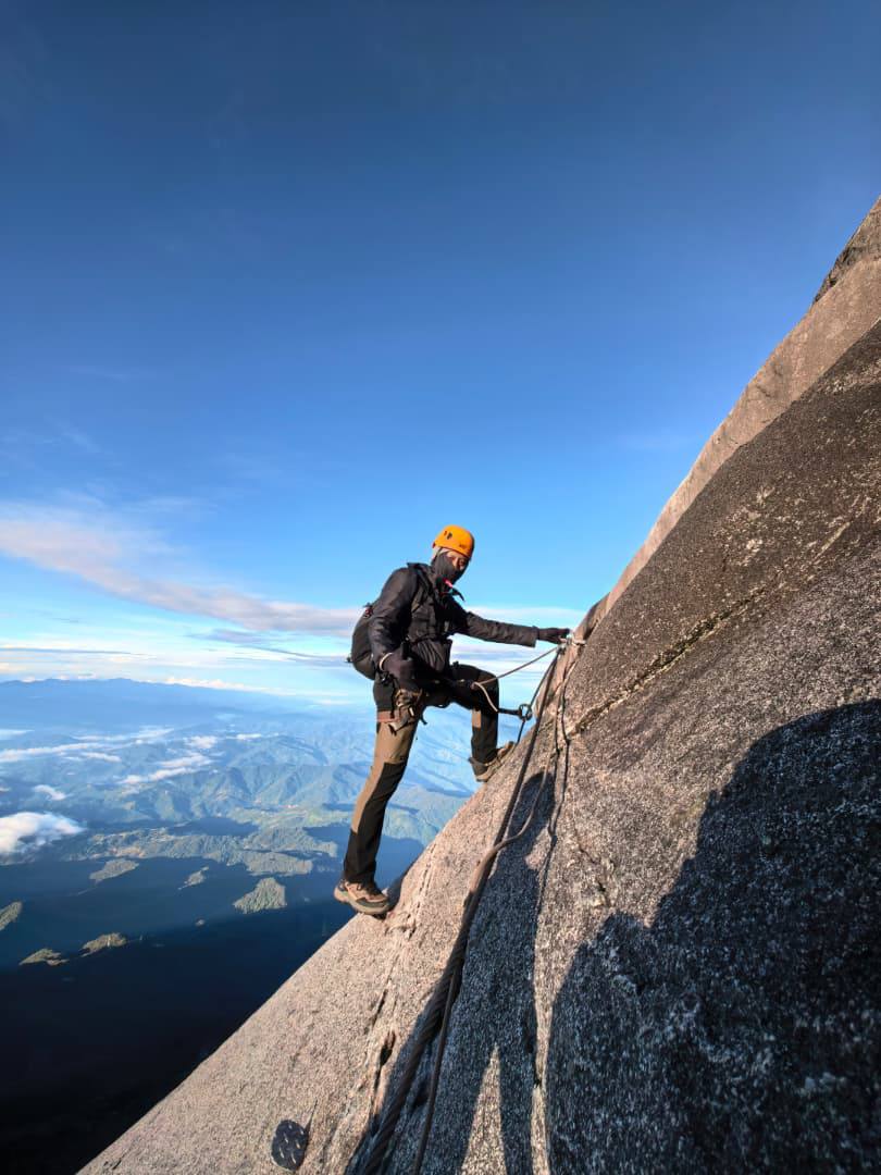Syahmul Aziz climbing a mountain via ferrata